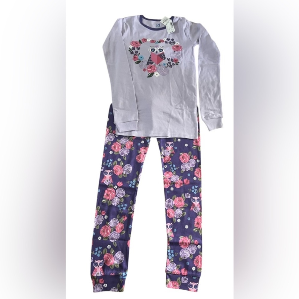 The PJ Place Girls pajama set. 
Purple floral Size 12
NWT